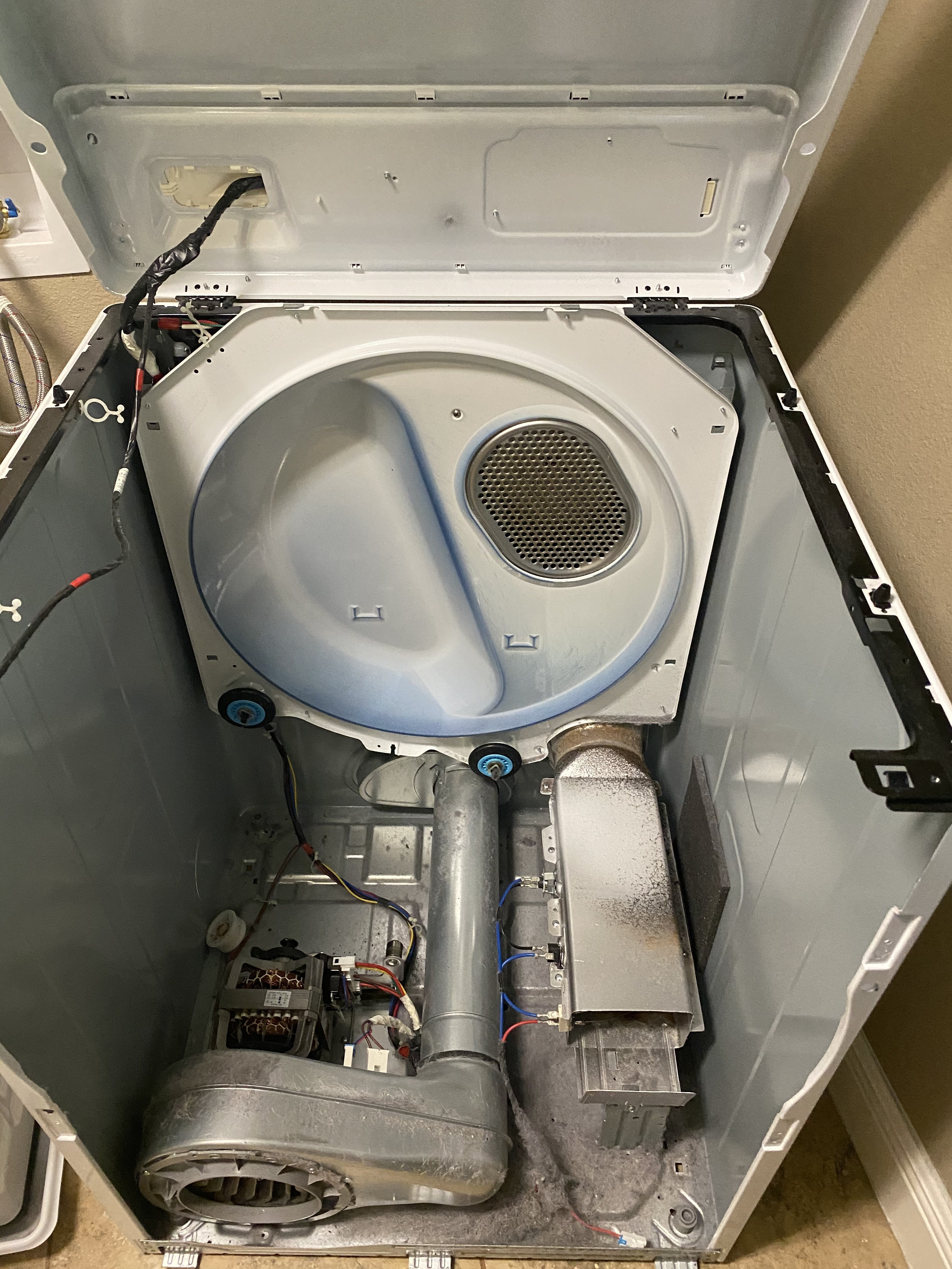 Dryer heating element duct and blower assembly exposed during repair — Tampa Bay