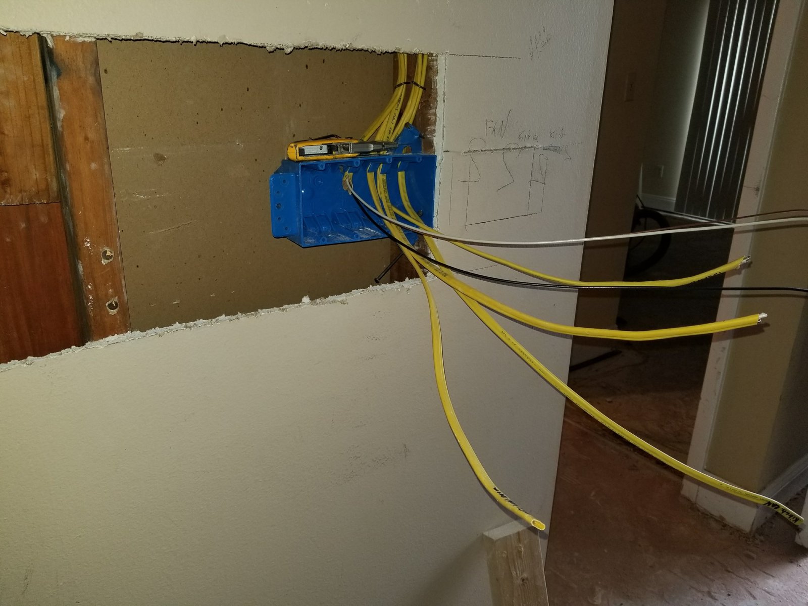 Fixer Service electrician running a new dedicated circuit for an EV charger — Tampa Bay