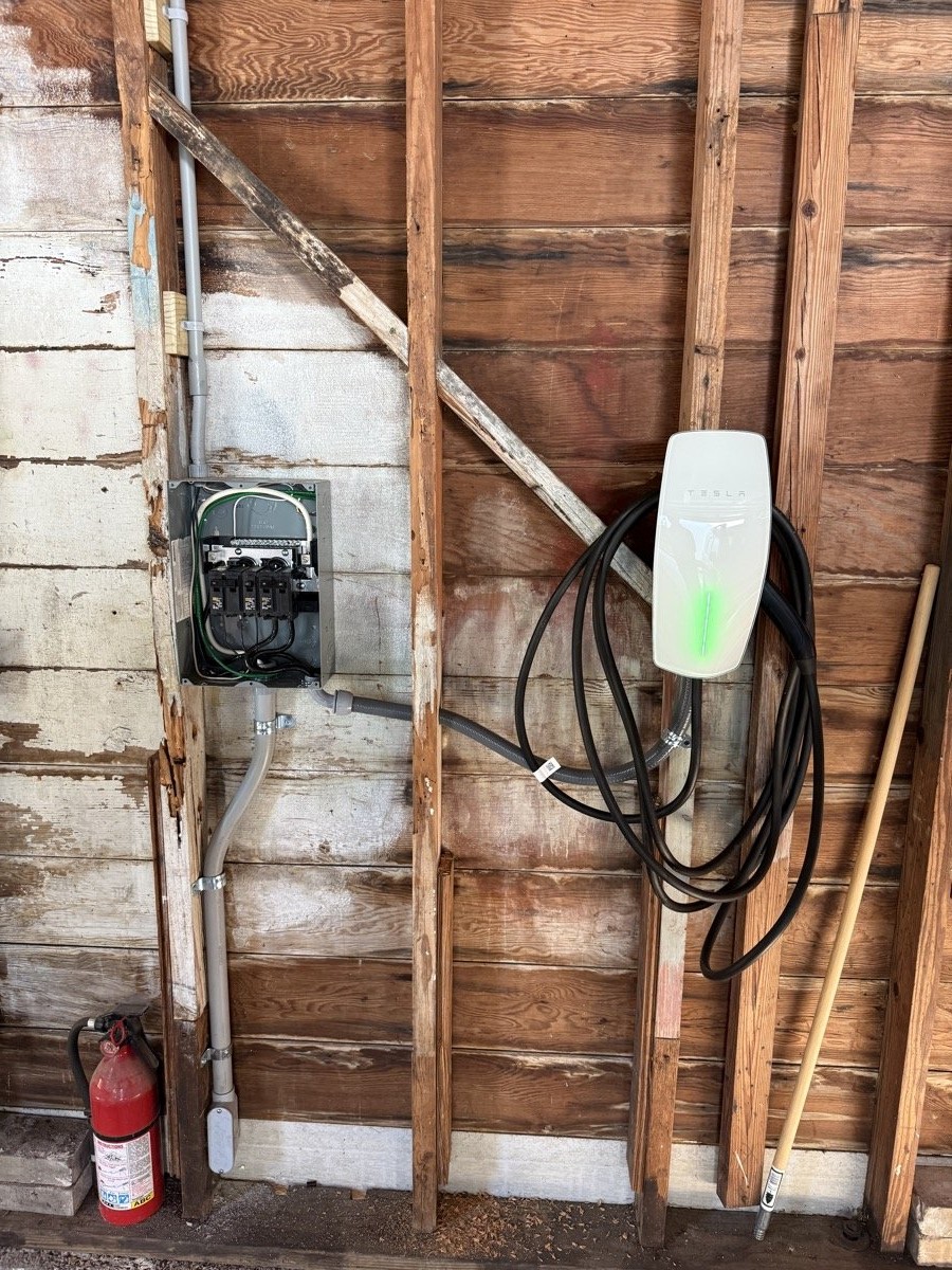 Completed Tesla Wall Connector EV charger installation in a Tampa Bay garage