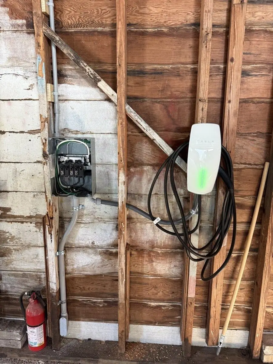 Completed Tesla Wall Connector EV charger installation in a Tampa Bay garage