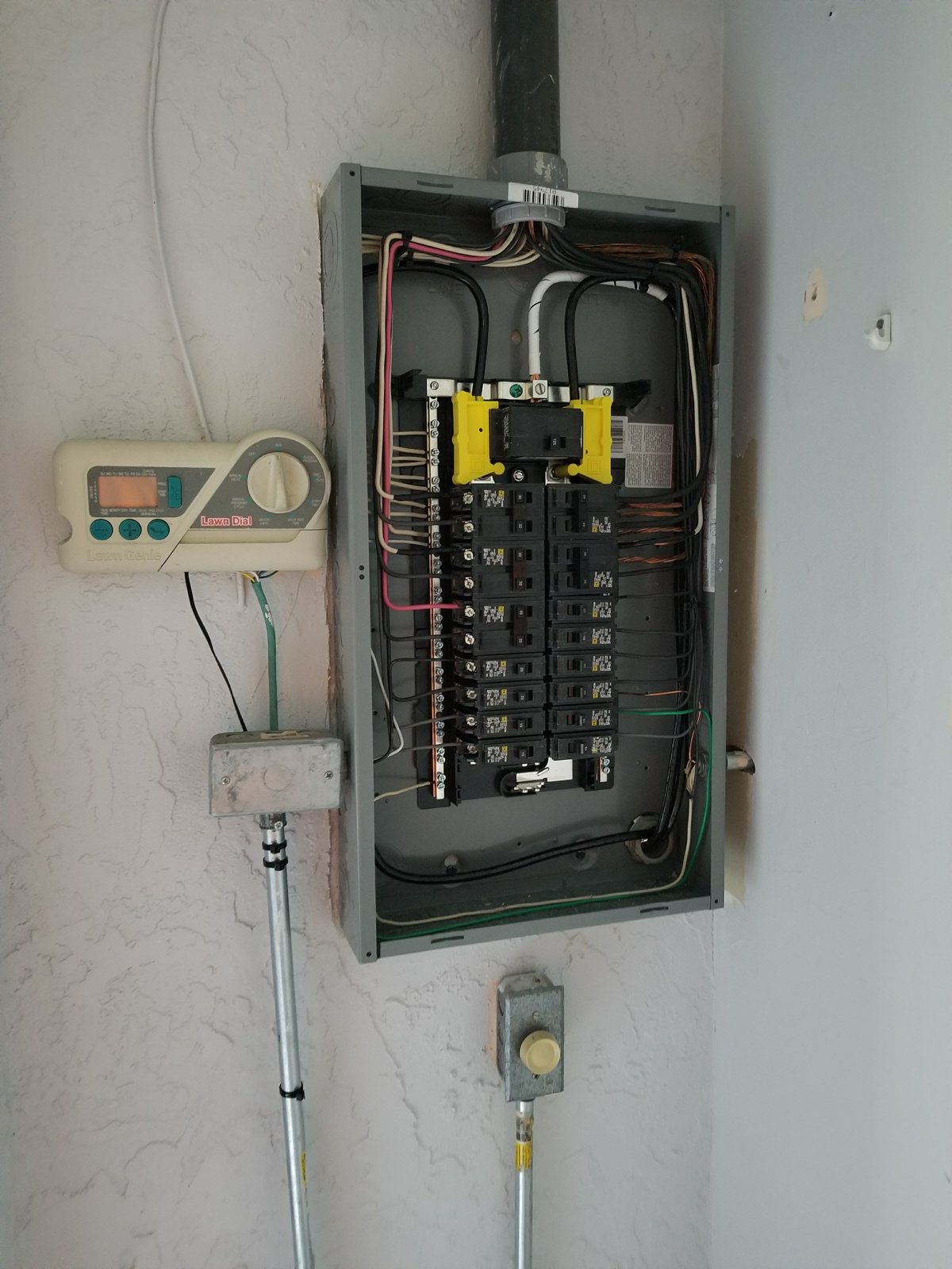 Fixer Service electrician assessing an open electrical panel's capacity before an EV charger installation in Tampa Bay
