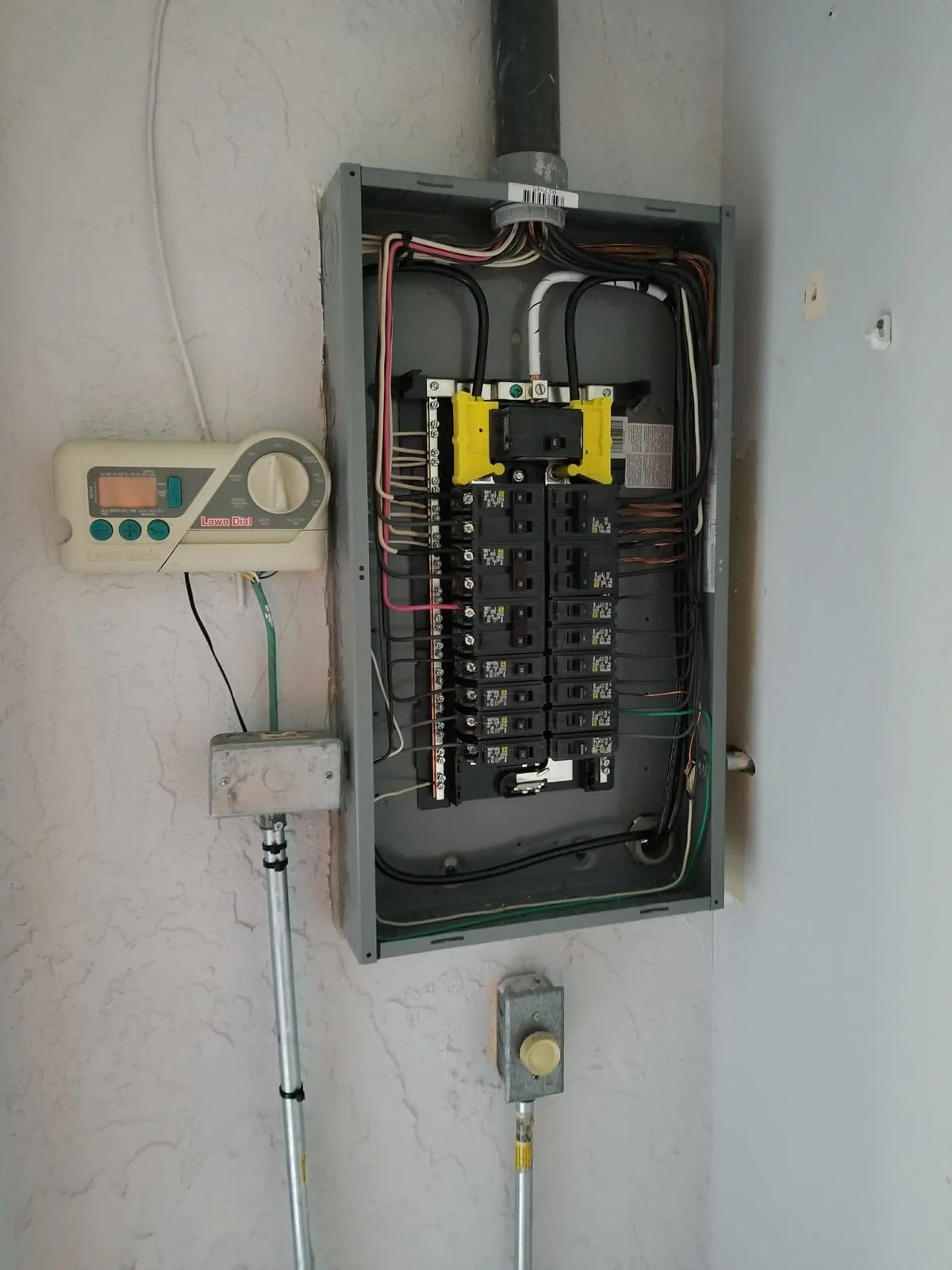 Fixer Service electrician assessing an open electrical panel's capacity before an EV charger installation in Tampa Bay