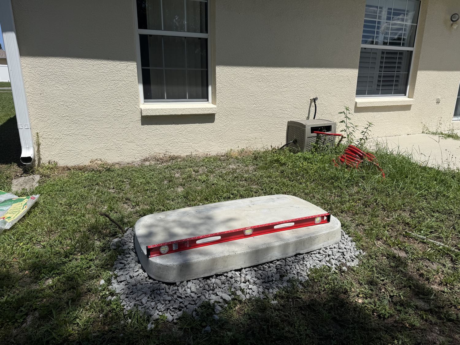 Concrete pad and gravel bed leveled before a Generac generator installation in Tampa Bay