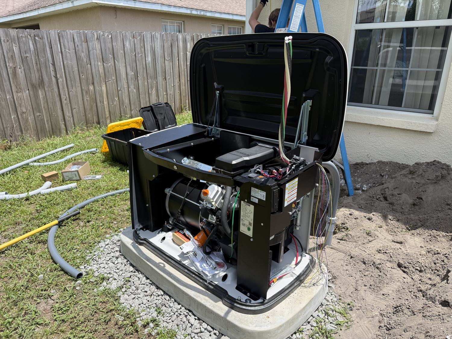 Electrician running electrical conduit and wiring the automatic transfer switch on a Generac installation in Tampa Bay