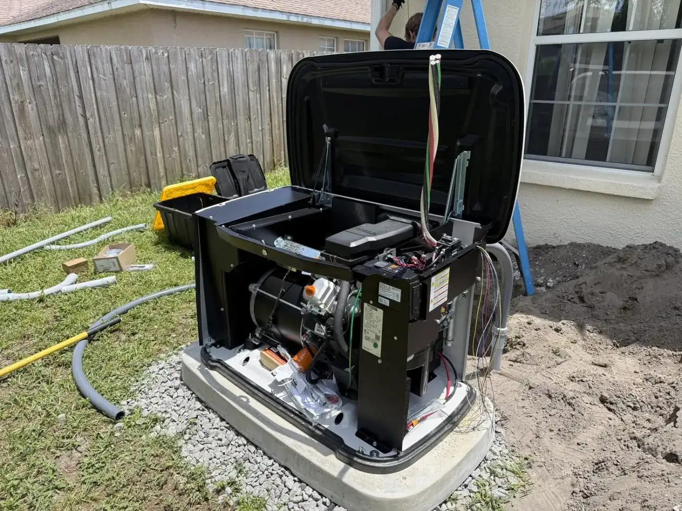 Electrician running electrical conduit and wiring the automatic transfer switch on a Generac installation in Tampa Bay