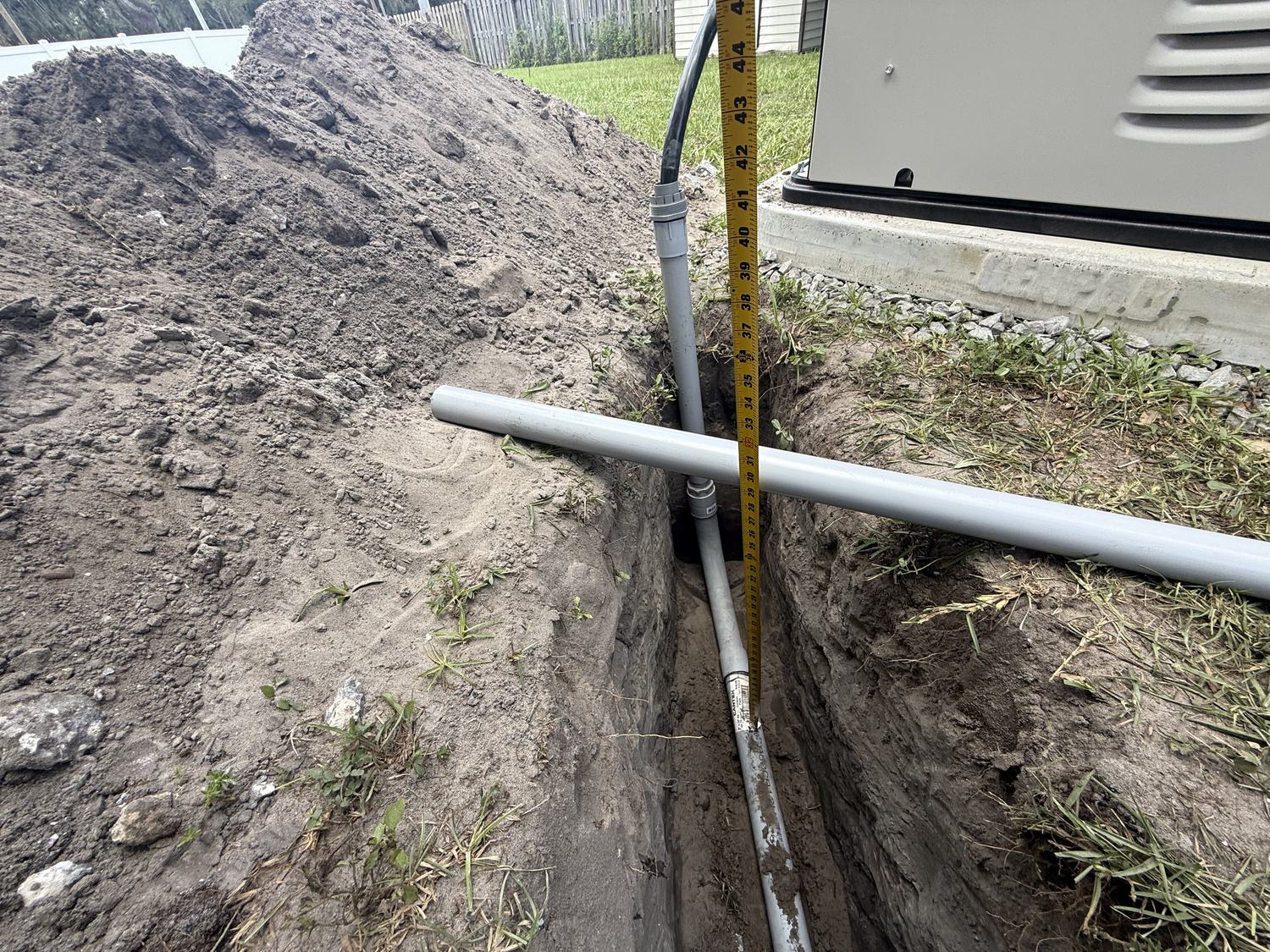 Gas line trench measured and prepared for a Generac generator connection in Tampa Bay