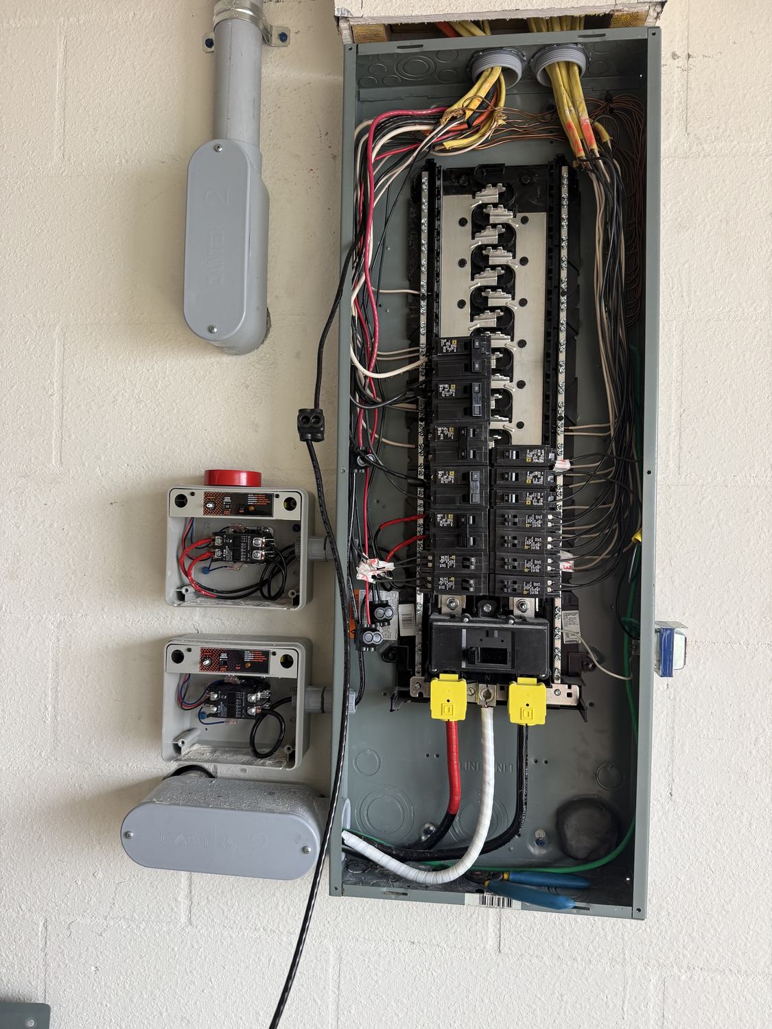Electrician tying a Generac transfer switch into the main electrical panel in a Tampa Bay home