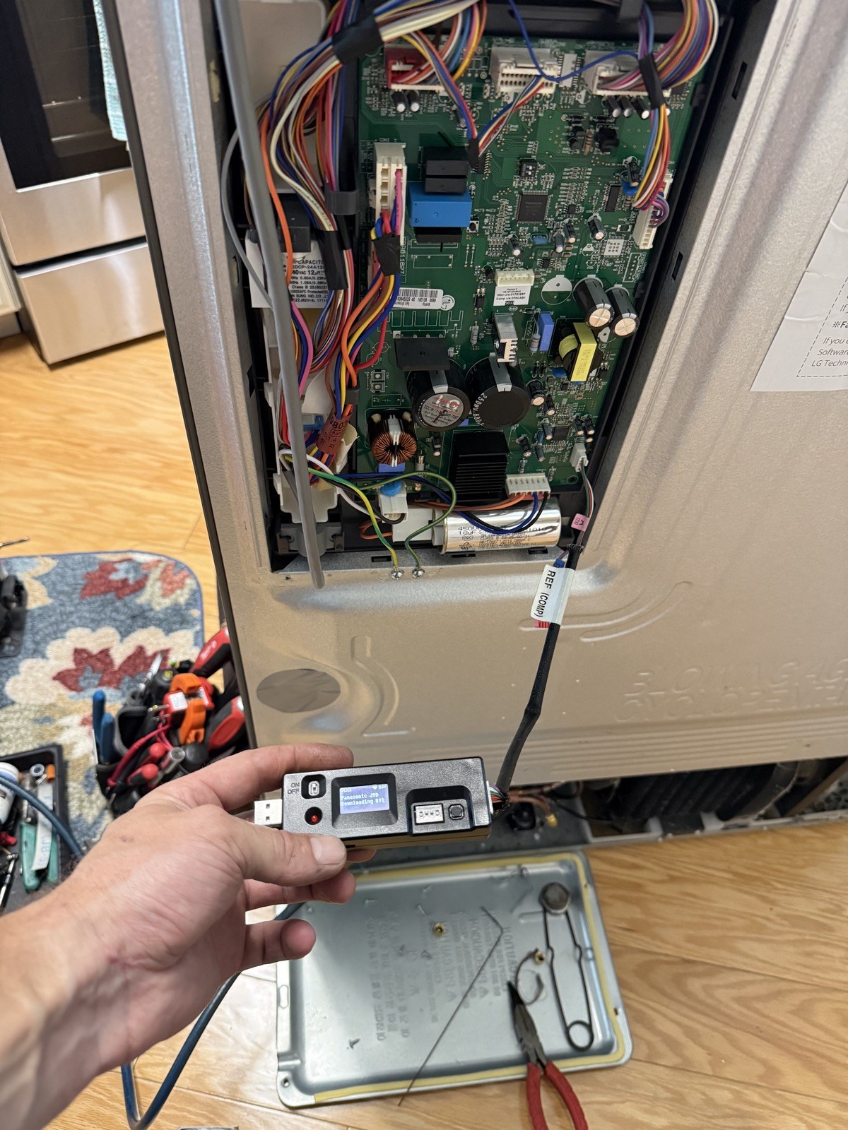 LG refrigerator control board and inverter exposed during diagnosis in New Port Richey