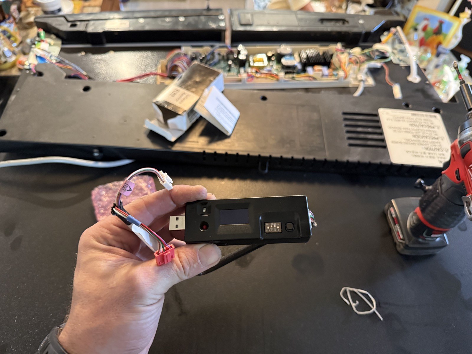 Fixer Service technician testing an LG linear compressor inverter with a diagnostic tool in Tampa Bay