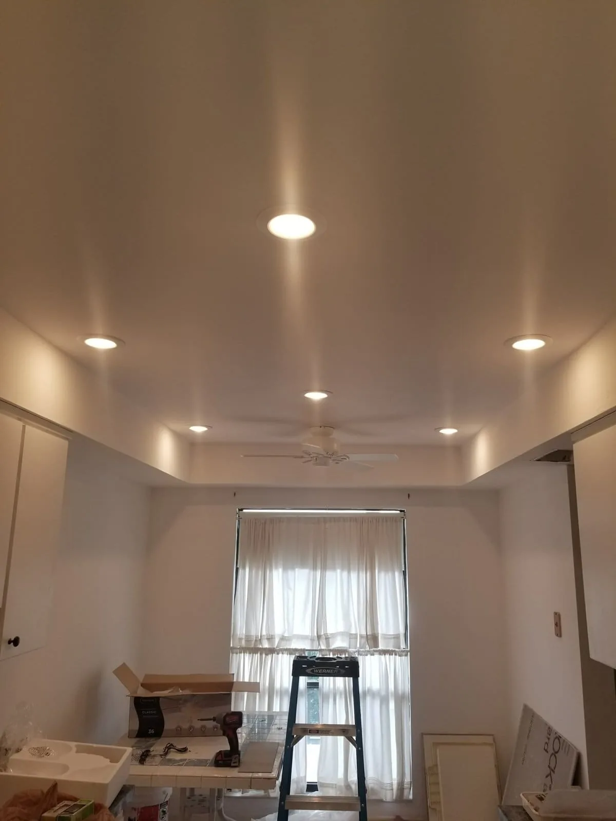 Recessed lighting installed across a living room ceiling in Tampa Bay