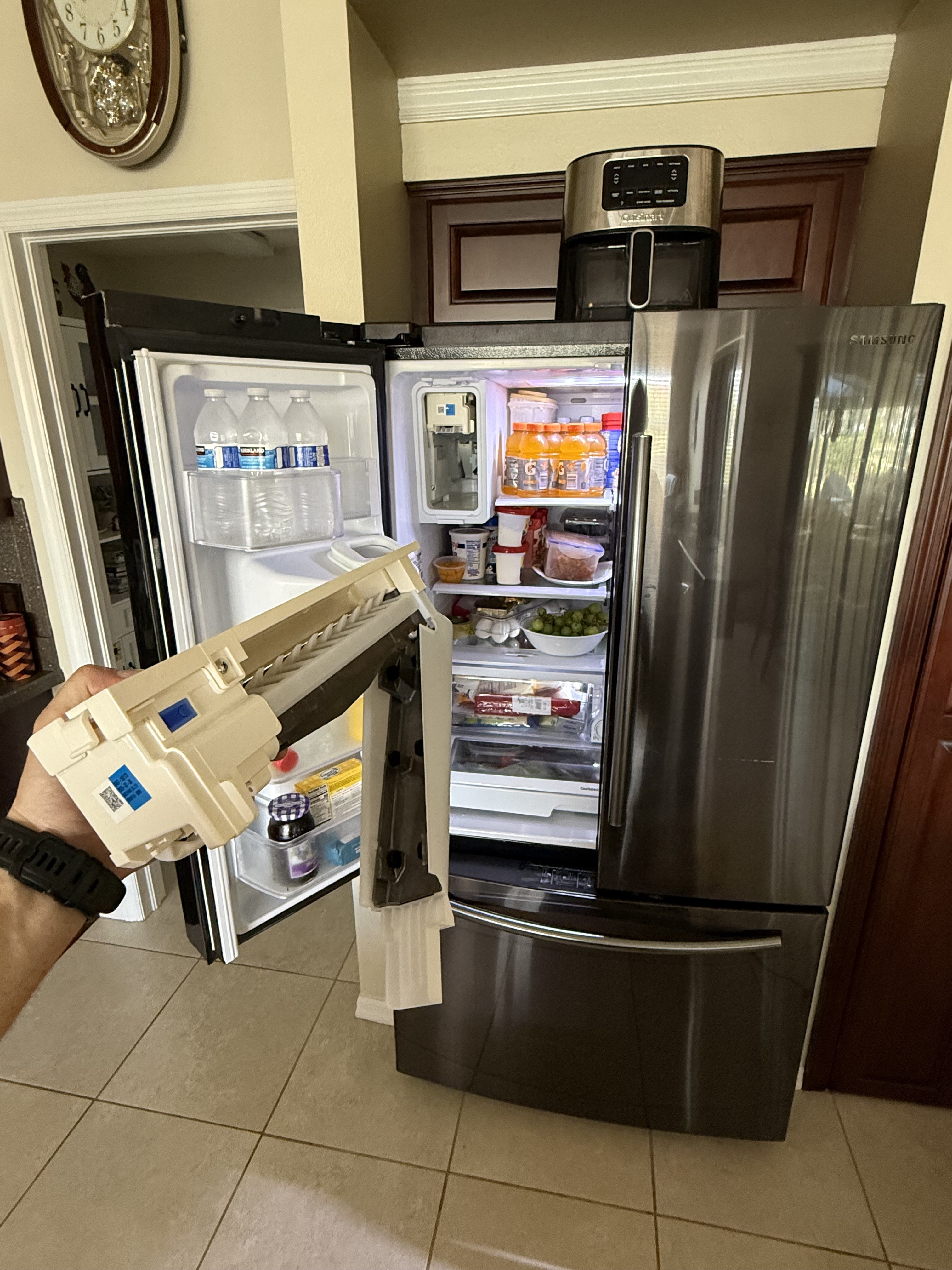Refrigerator ice maker assembly removed for replacement in Tampa Bay