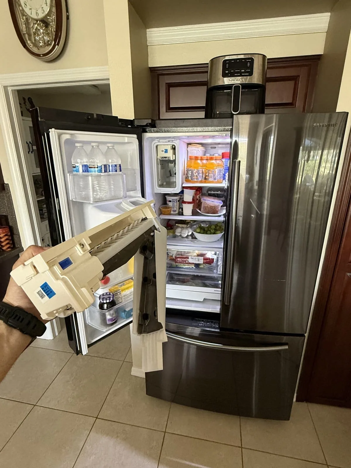 Refrigerator ice maker assembly removed for replacement — Tampa Bay appliance repair