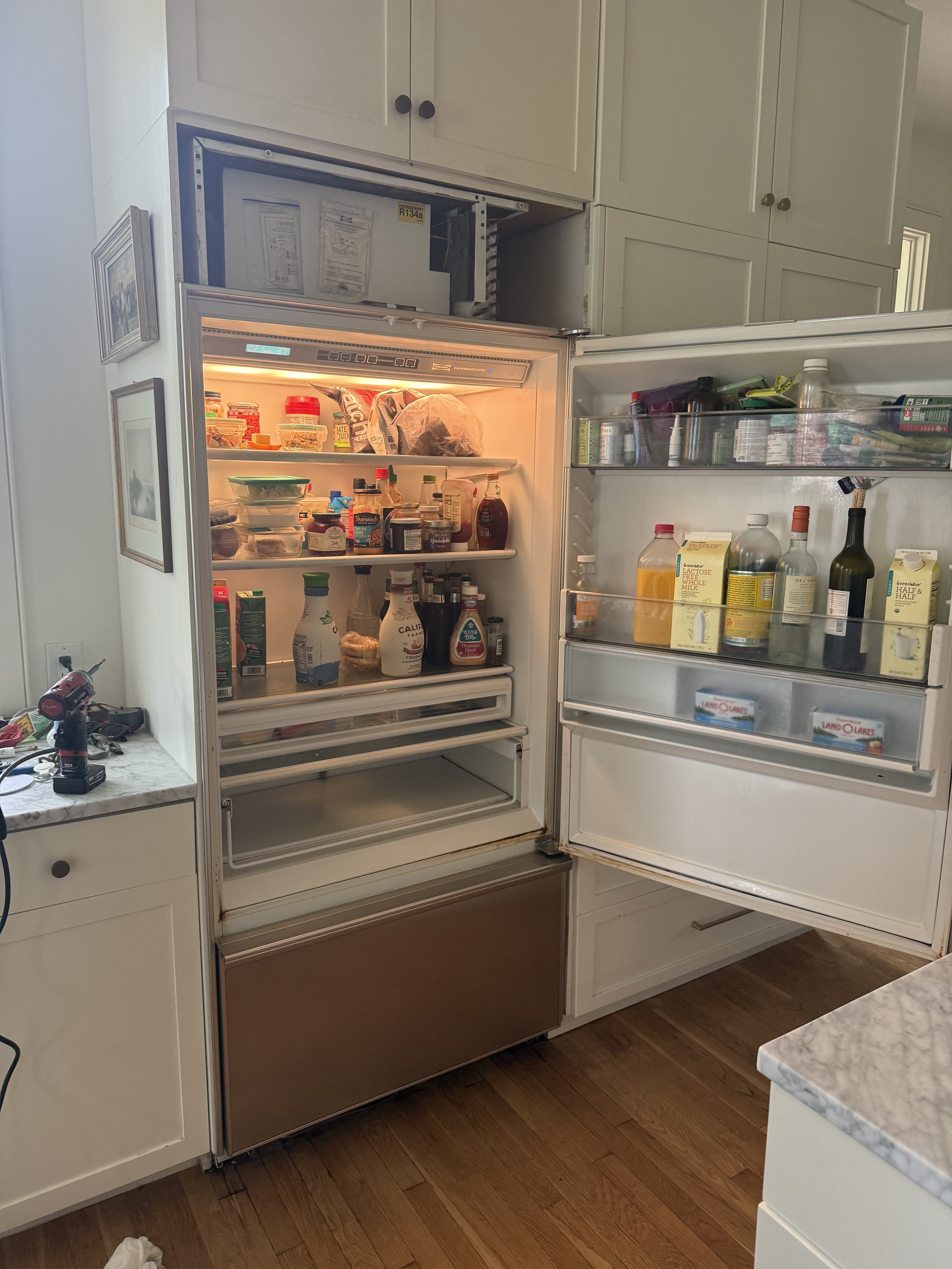 Sub-Zero refrigerator with all interior compartments open during service — Tampa Bay