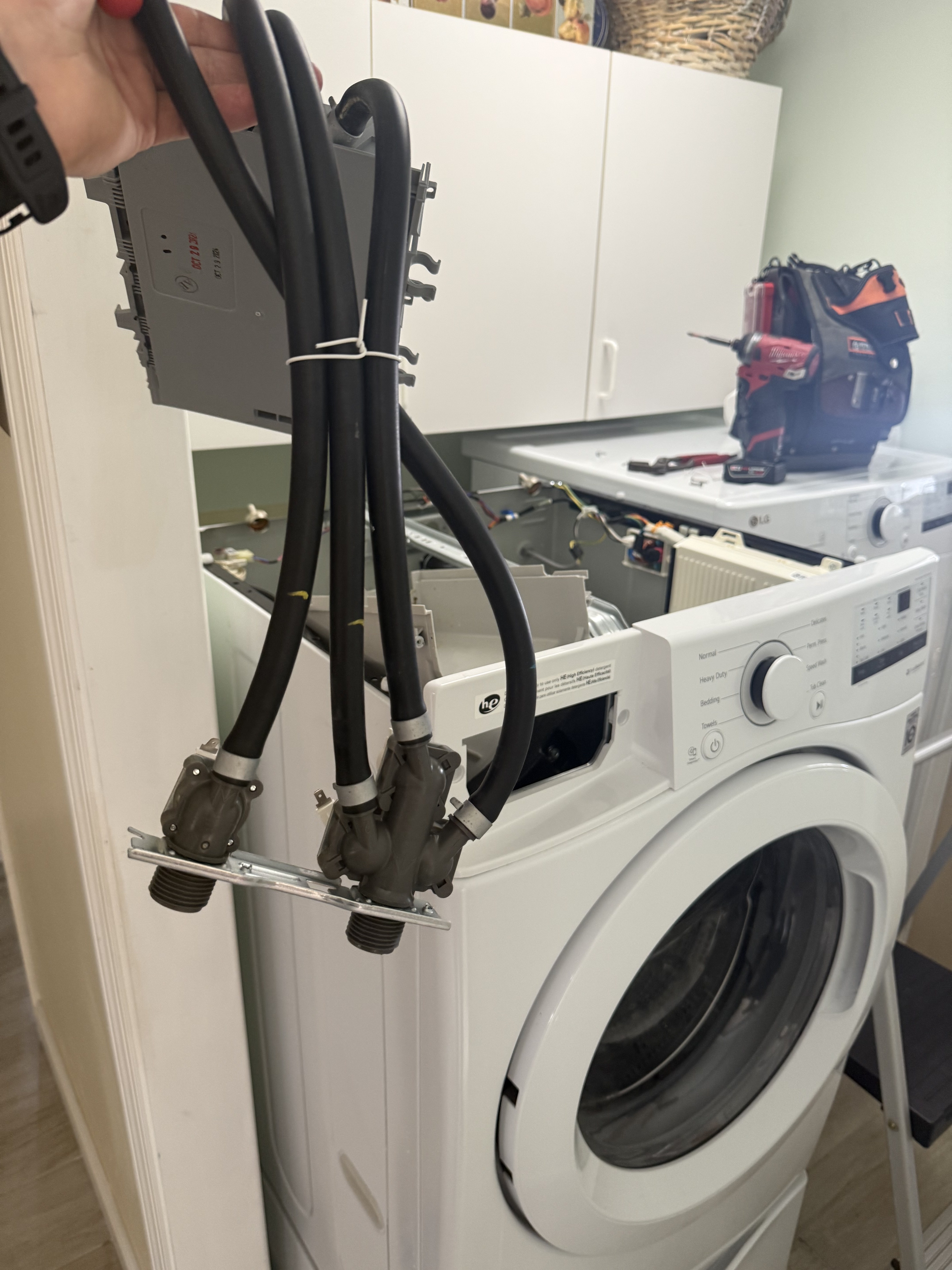 Front-load washer water inlet valve assembly during a washer repair near Tampa Bay