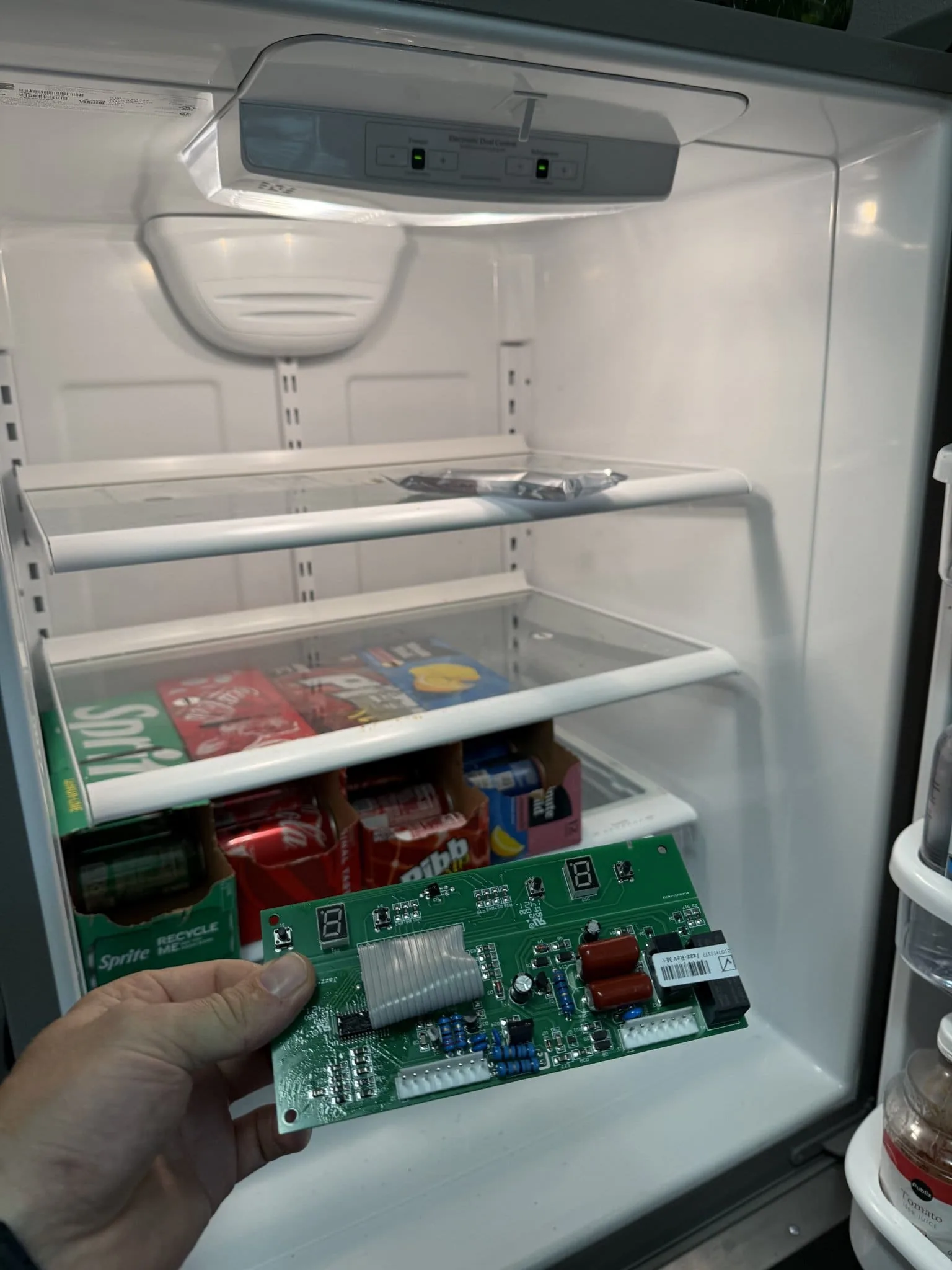 Fixer Service technician holding Whirlpool refrigerator control board during Palm Harbor repair