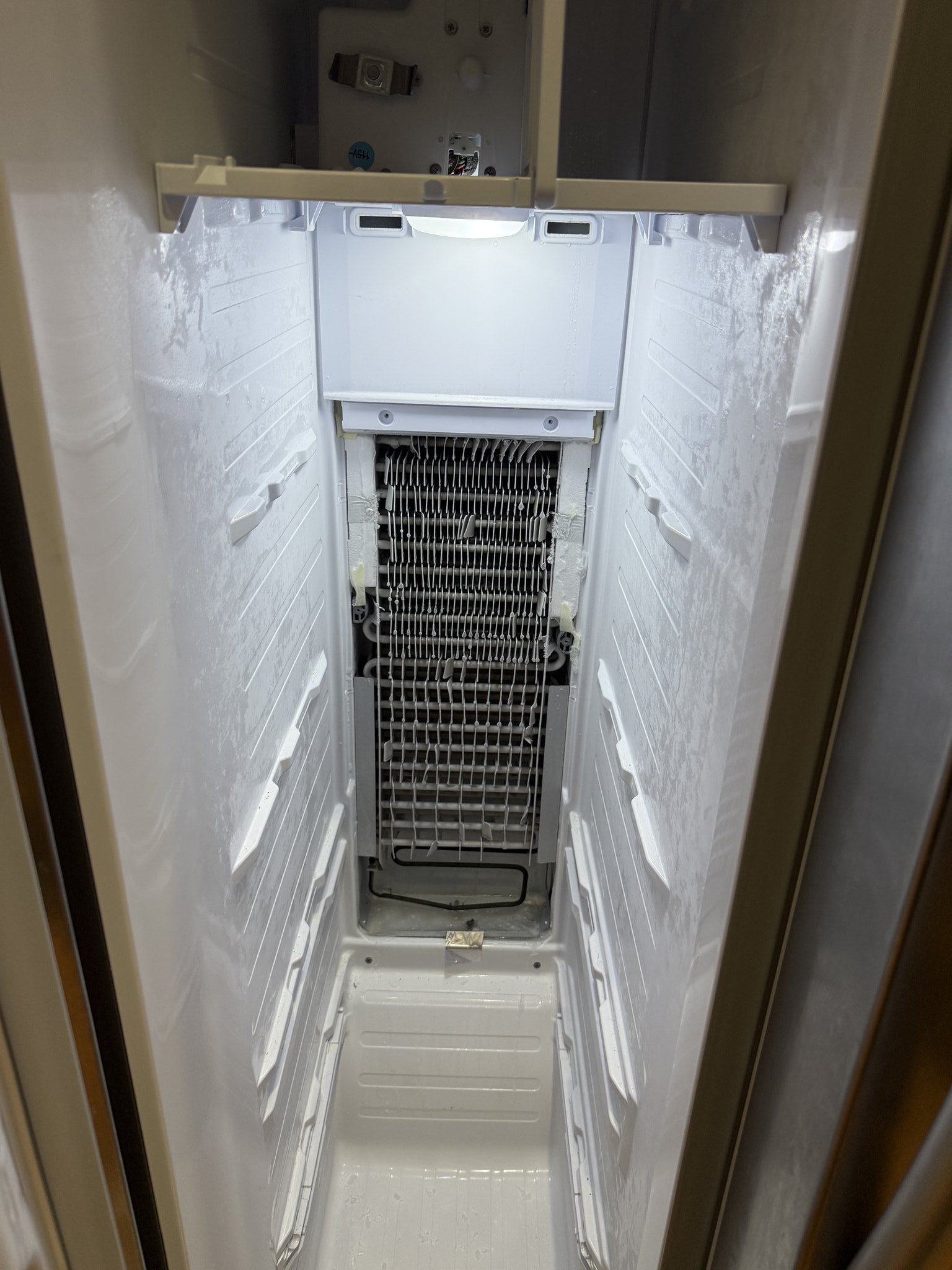 Whirlpool refrigerator evaporator coils with severe frost buildup — defrost system failure Palm Harbor FL
