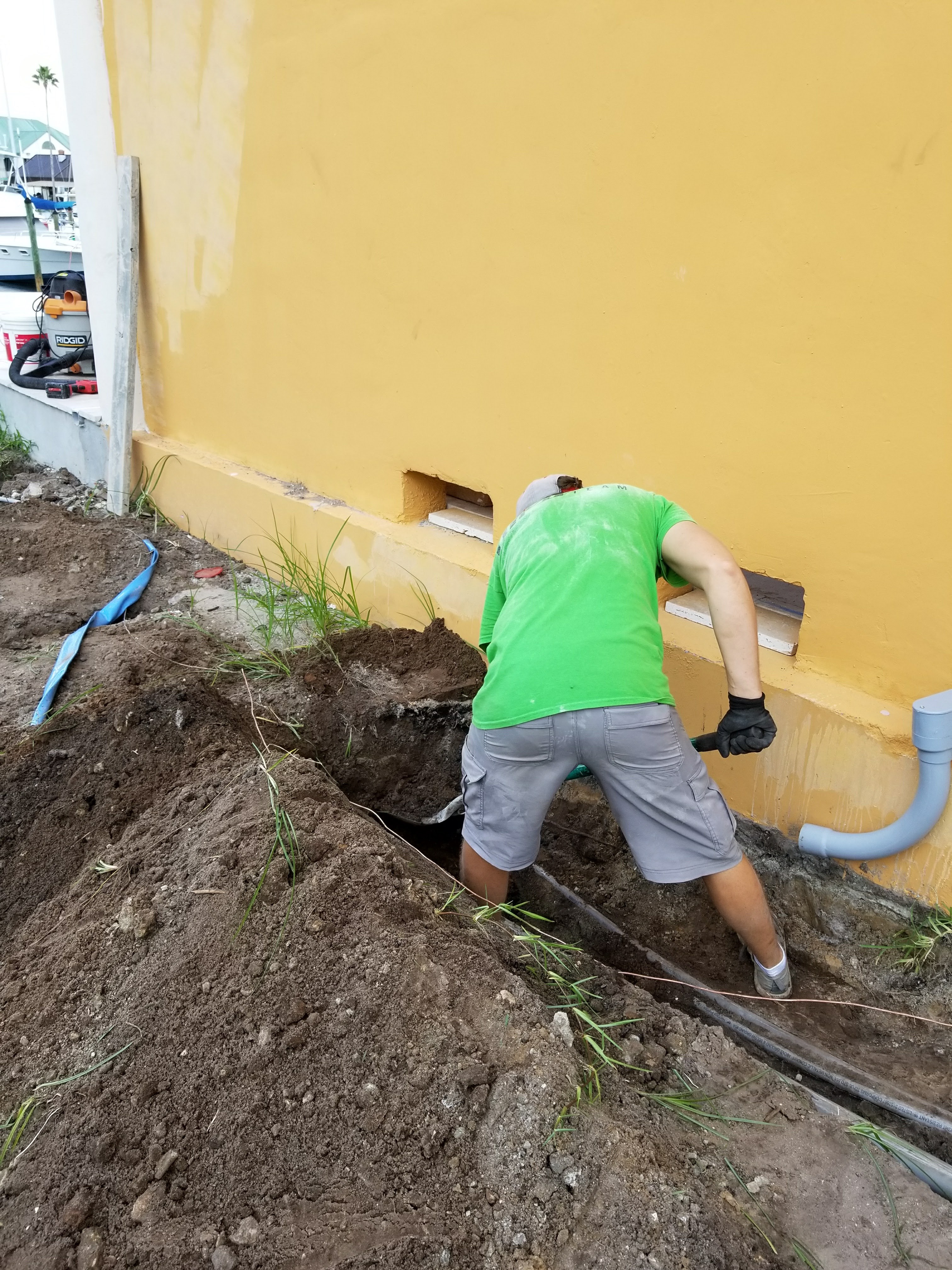 Fixer Service electrician running underground conduit into a home in Tampa Bay